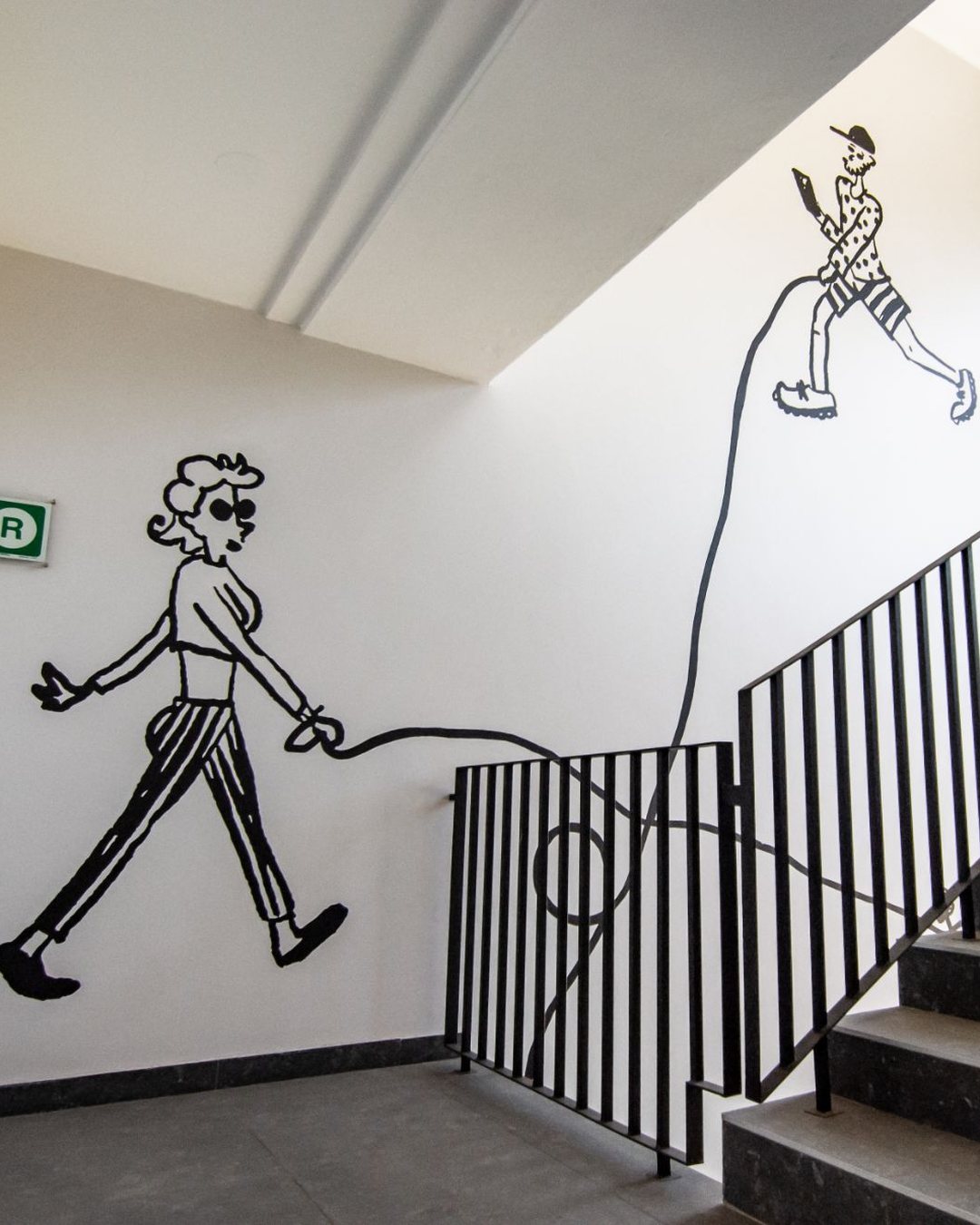 Hyatt House Johannesburg: a line-drawn mural of two walkers climbing the stairwell wall